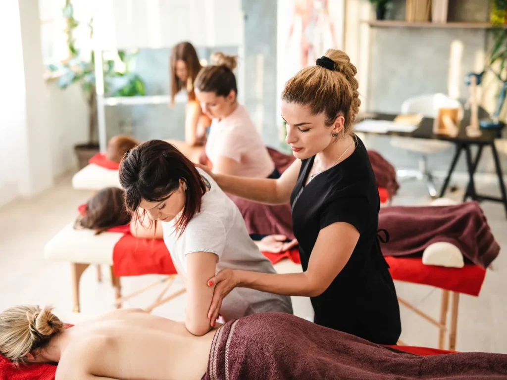 mobile sports massage therapist providing a professional back massage