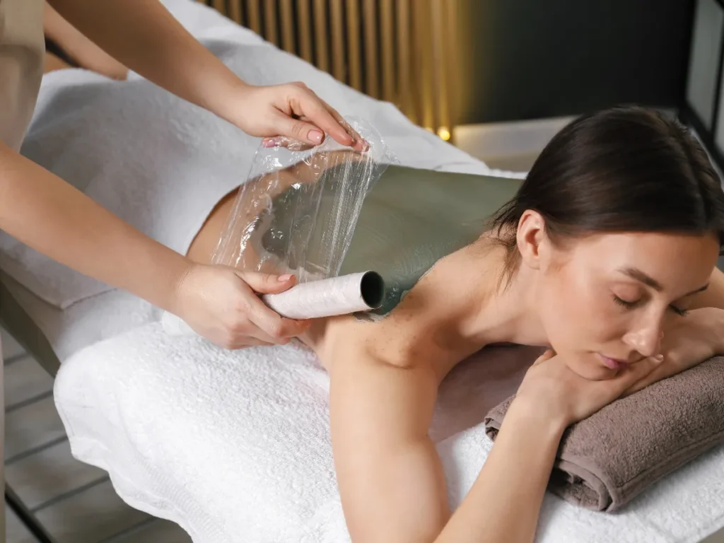 spa therapist providing a relaxing back treatment to a clint